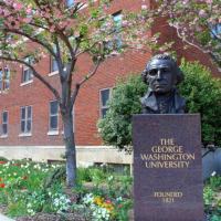 GWU campus with trees and bust of George Washington